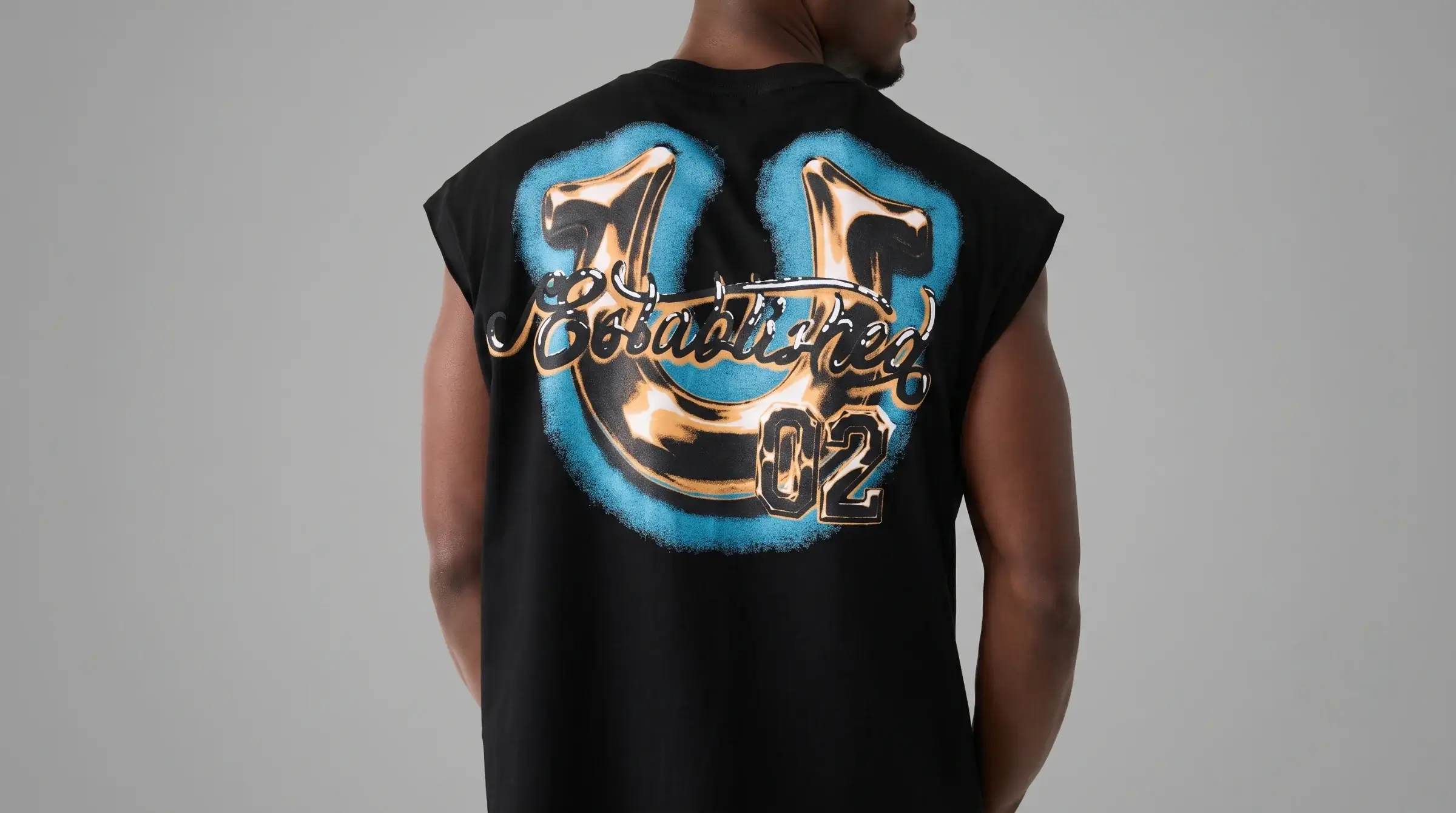 Model wearing an airbrushed graphic tee with a colorful Y2K-inspired design